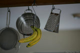 Hanging Banana And Kitchen Utensils A8V9629